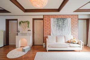 a living room with a couch and a fireplace at Traditional Korean houses Stay Yeon in Busan
