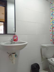 a bathroom with a sink and a toilet at Hostal Tayupanda in Quito