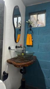 a bathroom with a glass sink and a mirror at Cabaña la Industrial in Coveñas +22 photos