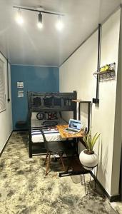 a room with a table with a laptop on it at Cabaña la Industrial in Coveñas