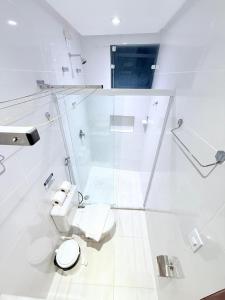 a white bathroom with a toilet and a shower at Vila do Morro Pousada in Morro de São Paulo +92 photos