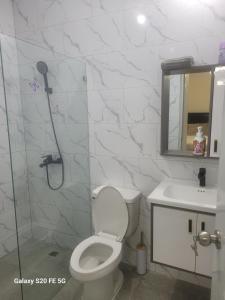 a bathroom with a shower and a toilet and a sink at " Bienvenido a casa " in San Pedro de Macorís