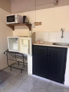 a kitchen with a sink and a microwave at Azahares in Termas del Daymán