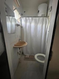 a small bathroom with a toilet and a sink at Azahares in Termas del Daymán