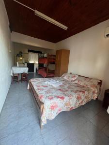 a bedroom with a bed and a table in a room at Azahares in Termas del Daymán