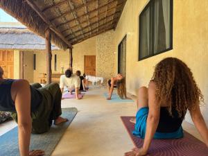 a group of people doing yoga in a building at Casa Boutique Coco Calin in Sisal