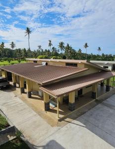 a building with a brown roof on top of it at Beach House - Maninoa in Maninoa