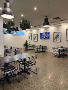 a room with tables and chairs and pictures on the wall at Grafton Hotel in Grafton