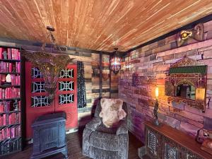 a living room with a chair and a brick wall at Luminary Lodge in Sevierville