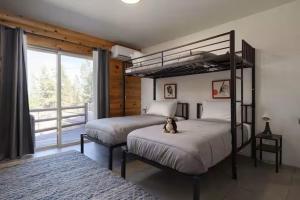 a bedroom with two bunk beds with a teddy bear sitting on top at Sisters Cabin in Sisters