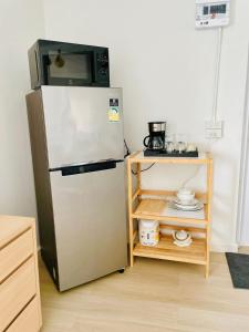a kitchen with a refrigerator and a microwave at Peaceful Hideaway with Stunning View Beach Access in Mae Nam