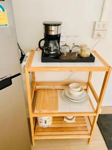 a table with a coffee maker and plates on it at Peaceful Hideaway with Stunning View Beach Access in Mae Nam +24 photos