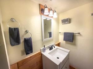 a bathroom with a white sink and a mirror at Inside Yosemite Park-Cozy Corner Unit-Sleeps 2 in Yosemite West +14 photos