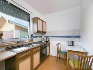 a kitchen with a sink and a window at Ferienwohnung in der Vulkaneifel in Winkel