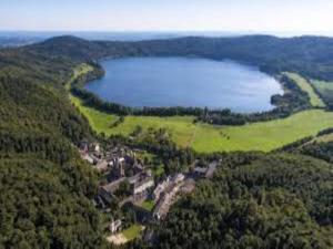 an aerial view of a lake in the hills at Ferienwohnung in der Vulkaneifel in Winkel +23 photos