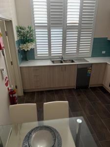 a kitchen with a sink and a counter top at Belmore Living in Goulburn +57 photos