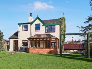 a large white house with a large window at Bridge House in Overseal +1 photo
