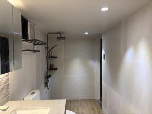 a bathroom with a shower and a toilet and a sink at Elev Ph - Staycation Penthouse in San Nicolas