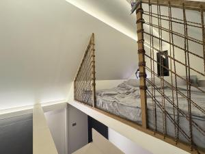 a room with a bed in a loft at Elev Ph - Staycation Penthouse in San Nicolas