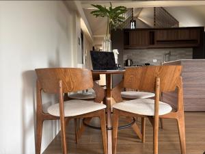 a kitchen with a table with two chairs and a laptop at Elev Ph - Staycation Penthouse in San Nicolas +17 photos