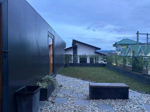 a house with a black wall and a courtyard at Elev Ph - Staycation Penthouse in San Nicolas