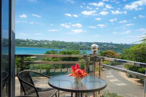 a table on a balcony with a view of the water at Crown Royale Hotel & Lounge in Port Vila