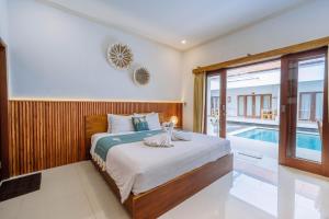 a bedroom with a bed and a swimming pool at MIMU C-O Living in Kerobokan +25 photos