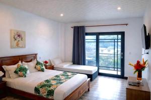 a hotel room with a bed and a balcony at Crown Royale Hotel & Lounge in Port Vila +19 photos