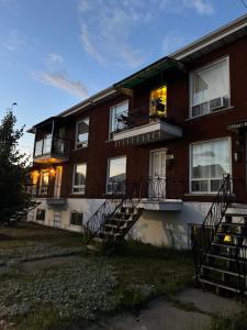 a brick apartment building with stairs and windows at Barel Residence Homestay - Free Parking - 15min MTL in Longueuil