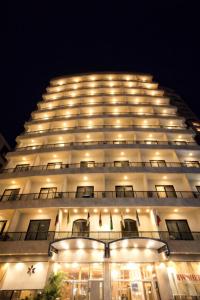 a large white building with lights on it at night at Rawsheh Boutique Hotel in Beirut