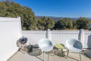 a group of chairs and tables on a patio at Creature Comforts Suite-Private Hot Tub-Sleeps 2 in Ahwahnee +3 photos