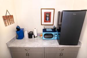 a counter with a microwave on top of a kitchen at Creature Comforts Suite-Private Hot Tub-Sleeps 2 in Ahwahnee