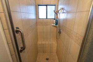 a bathroom with a shower with a window at Creature Comforts Suite-Private Hot Tub-Sleeps 2 in Ahwahnee