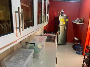 a kitchen with a sink and a refrigerator at Rancho Doña Rita in Higuey +34 photos