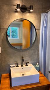 a bathroom with a white sink and a mirror at Duplex Playa Mansa in Mina Clavero +21 photos