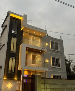 a large house with lights in front of it at Hotel DG Residency in Guwahati