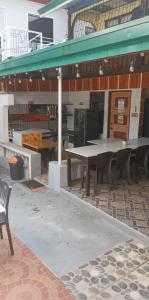 a picnic table in front of a building at Buena Lynnes Annex Lodge in Puerto Galera