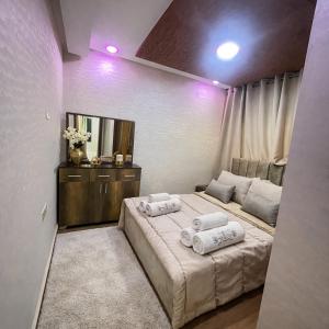 a bedroom with a large bed with two towels on it at Prime stay downtown Meknes in Meknès