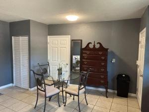 a dining room with a table and chairs and a dresser at Beach getaway - Private paradise - Clearwater in Clearwater +5 photos