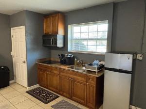 a kitchen with a sink and a refrigerator at Beach getaway - Private paradise - Clearwater in Clearwater