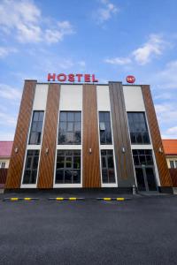 a hospital building with a sign on top of it at Hostel Mevazor in Katartal