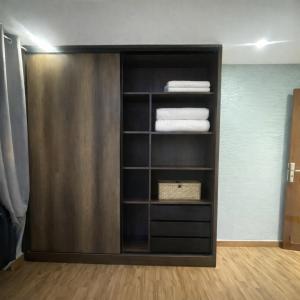 a book shelf with folded towels in a room at Prime stay downtown Meknes in Meknès +9 photos