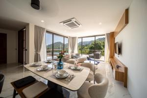 a living room with a table and chairs and a couch at Villa M3 De Samui in Nathon Bay