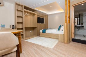 a bedroom with a bed and a desk and a television at Tritara Apartment in Kathmandu