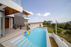 a swimming pool in the backyard of a house at Villa M3 De Samui in Nathon Bay