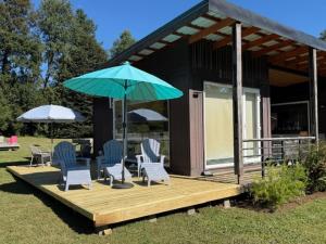a deck with chairs and umbrellas on a house at Rukachohan in Pucón +9 photos