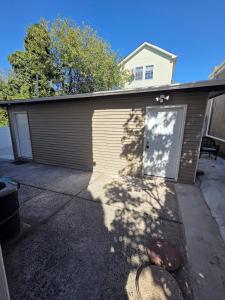 a house with a garage with a door at Queen Detached Studio 1 in Irvington