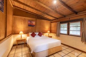 a bedroom with a bed in a room with wooden ceilings at Hotel Grand Panorama Lembang in Lembang +96 photos