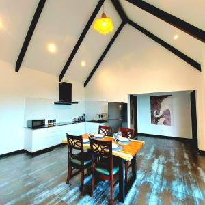 a kitchen and dining room with a table and chairs at Ing Suan pool villa 1 in Ao Nang Beach