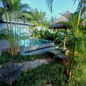 a villa with a swimming pool next to a house at Ing Suan pool villa 1 in Ao Nang Beach
